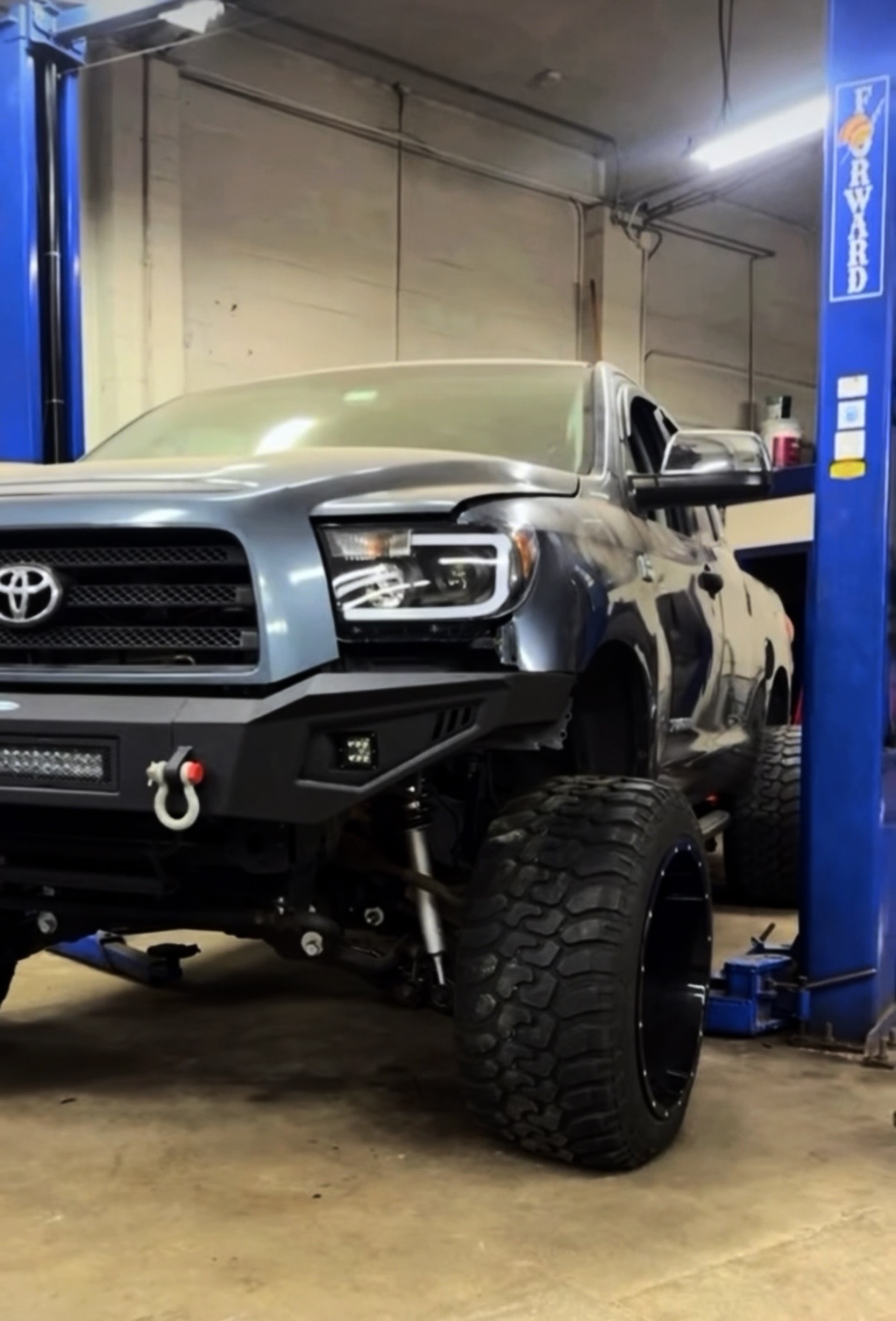 Lifted Toyota Tundra in the shop bay