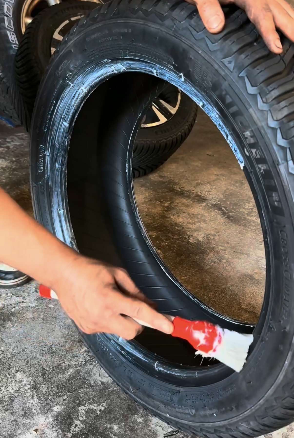 Technician mounting a new tire